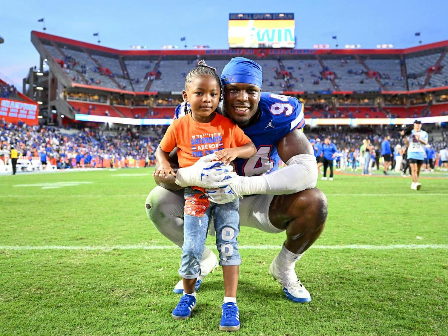 Florida Gators edge rusher Tyreak Sapp (94) stands with his daughter after a football game between the Texas Longhorns and the Florida Gators on Saturday, Oct. 4th, 2025, at Ben Hill Griffin Stadium in Gainesville, Fla.