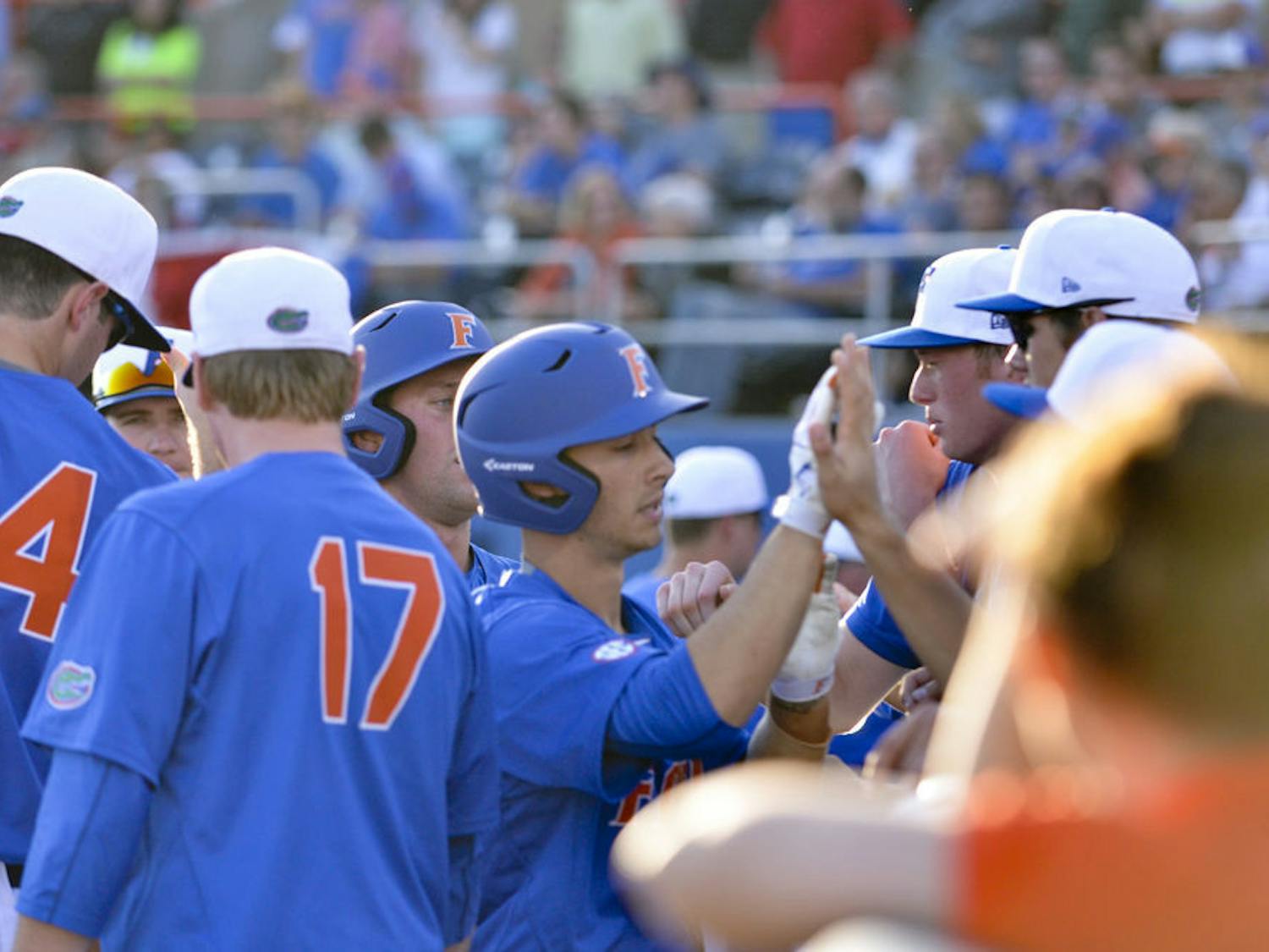 Third baseman Jonathan India (center) celebrates with teammates after India hit a sacrifice fly in the fourth inning of Florida's 8-4 win on Feb. 20, 2016. India was one of three freshmen to start at least one game in the Gators' opening weekend series against Florida Gulf Coast. Eight freshmen made at least one appearance over the three days.