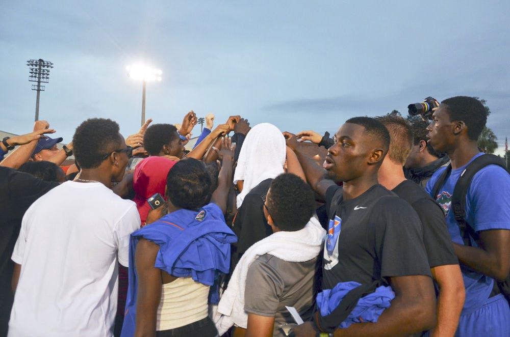<p>The Florida track and field team huddles together following the conclusion of the 2015 Florida Relays on Saturday at the Percy Beard Track.</p>