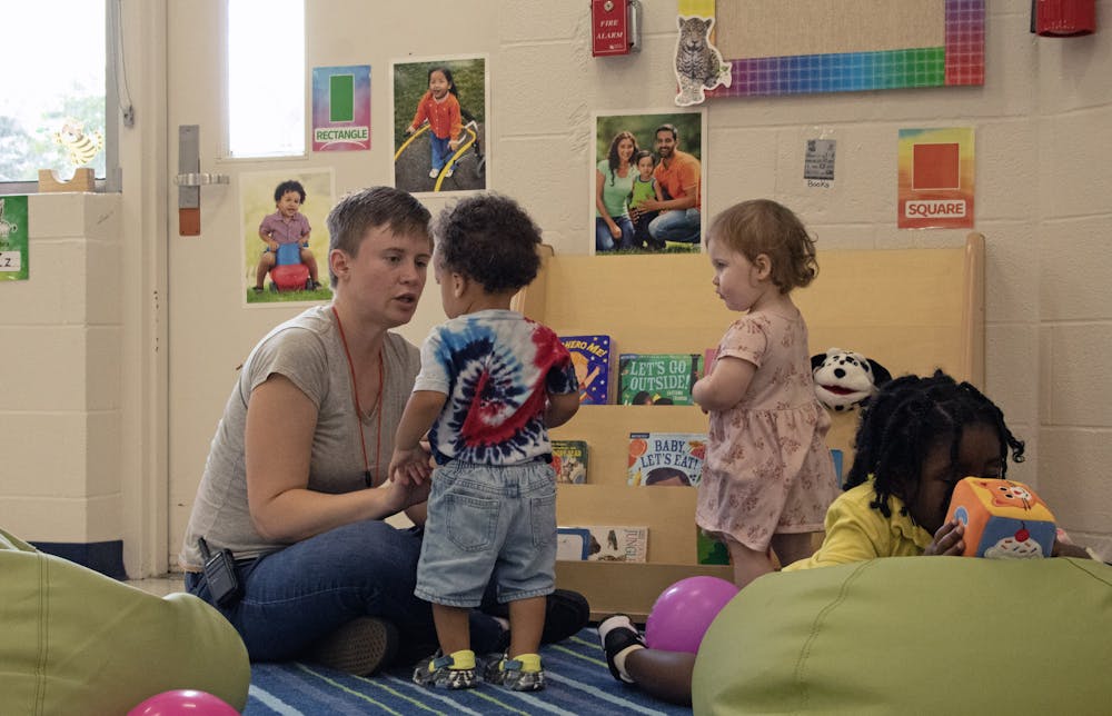 Jess Hunt, 33, addresses two students of the Gainesville Empowerment Zone’s one-year-old class Friday, Sept. 1, 2023.