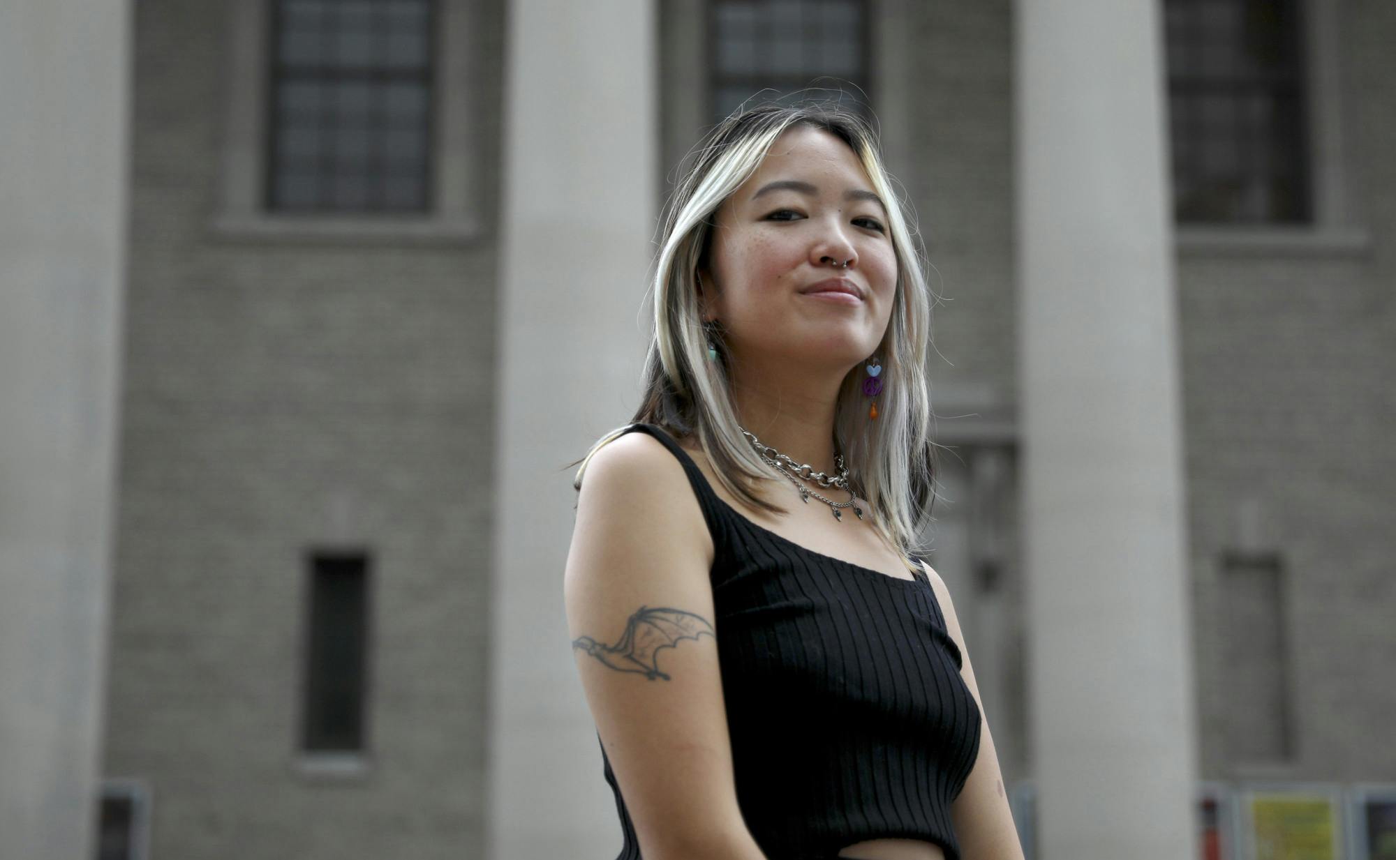 Emily Lube, 22, a UF botany alumna, also known as DJ Smushyslugs, poses in front of Hippodrome Theater in Gainesville on Thursday, July 1, 2021.