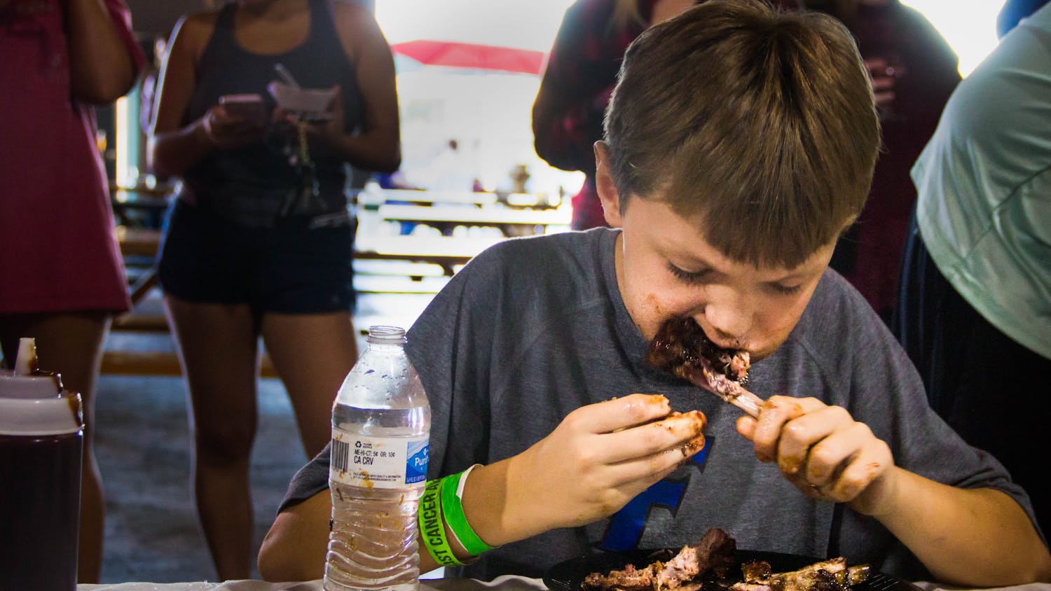Ten-year-old Taylor Brewer competes in the annual Adam’s Rib Co. Charity Rib Eating Contest Sunday at the First Magnitude Brewing Co. “He’s fired up and has been talking about it all day,” said his mother and co-owner of Adam’s Rib Co., Michele Brewer.