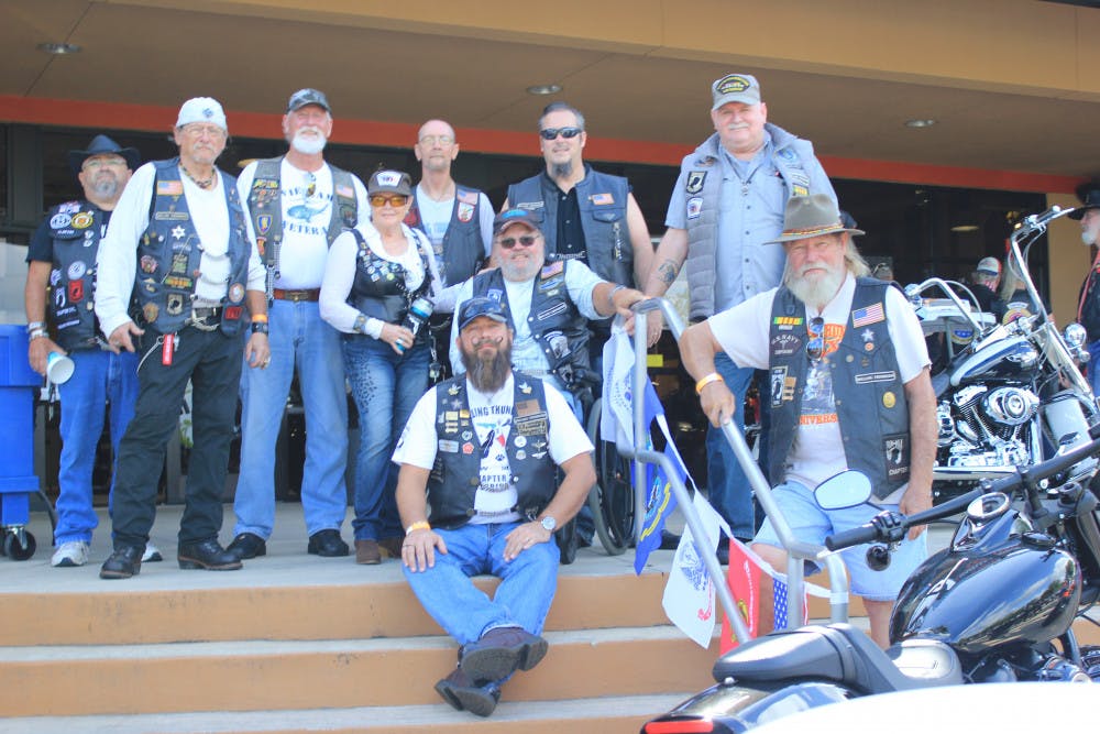<p>Members of Rolling Thunder pose for a group photograph outside of the Gainesville Harley-Davidson dealership.</p>