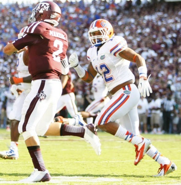 Freshman linebacker Antonio Morrison (12) chases down Texas A&amp;M quarterback Johnny Manziel (5) during UF's 20-17 victory against Texas A&amp;M at Kyle Field.