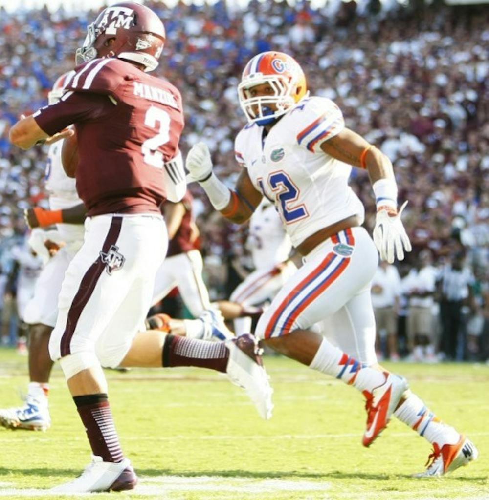 <p>Freshman linebacker Antonio Morrison (12) chases down Texas A&amp;M quarterback Johnny Manziel (5) during UF's 20-17 victory against Texas A&amp;M at Kyle Field.</p>