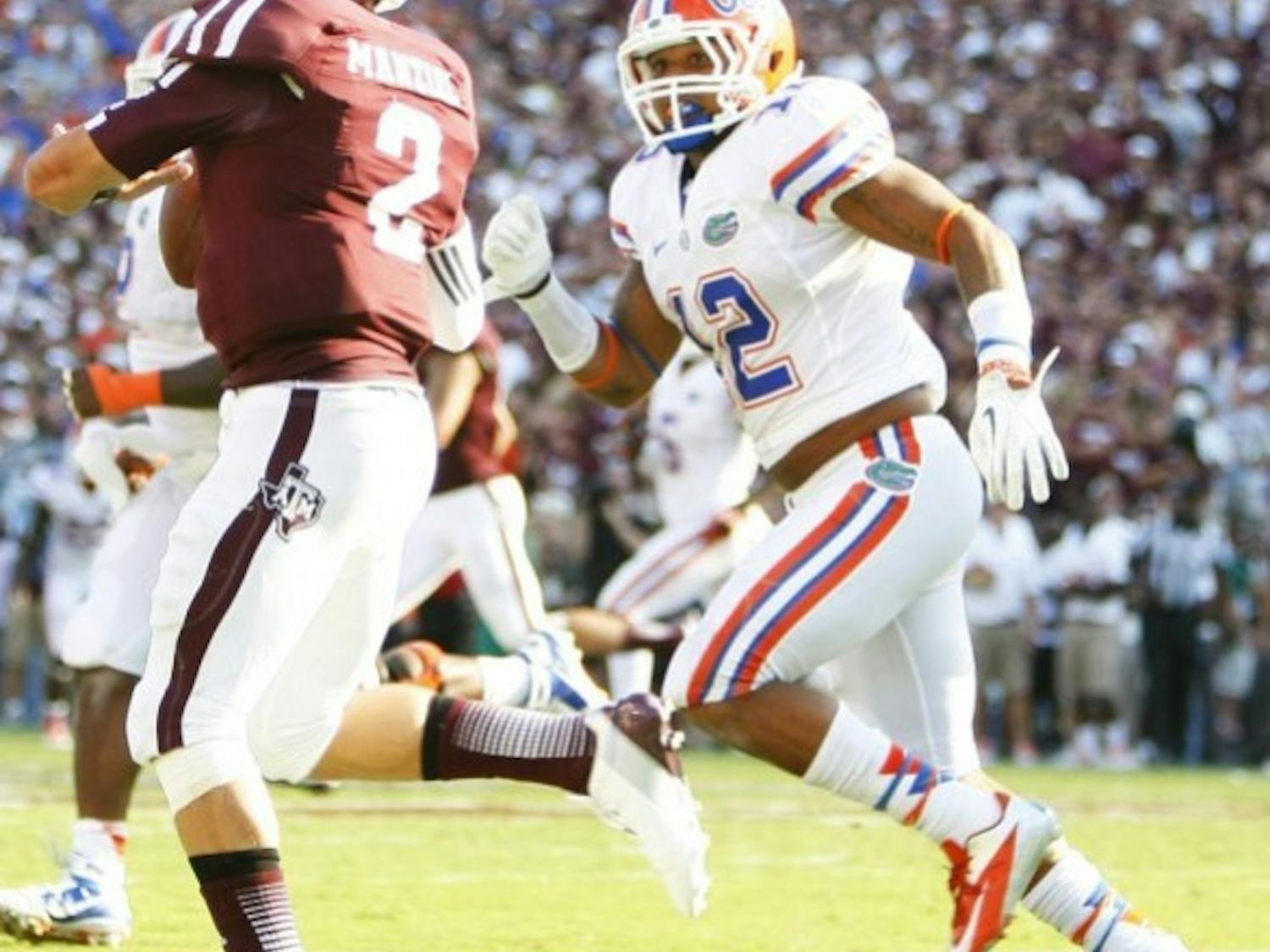 Freshman linebacker Antonio Morrison (12) chases down Texas A&M quarterback Johnny Manziel (5) during UF's 20-17 victory against Texas A&M at Kyle Field.