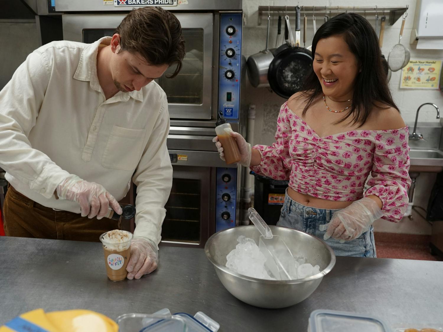 Kate Yeung and Bradon Ramirez, owners of Coterie Market, prepare their new iced superfood latte at Working Food Community Kitchen on Saturday, May 20th, 2023.