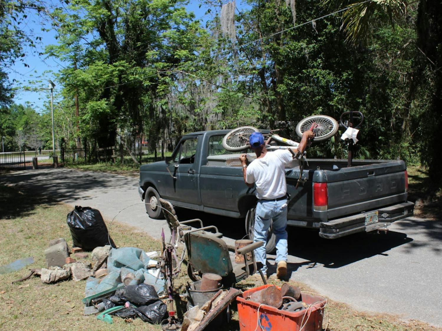 Mitchell George, 54, loads his pickup truck with a rusted bicycle outside an elderly Gainesville woman’s home on Saturday. George, who lives in the city’s Porters Community, hauled away junk UF students cleared from the woman’s home as a part of UF Student Government’s inaugural The Big Event, a service day involving about 760 students and about 45 locations throughout Gainesville. 