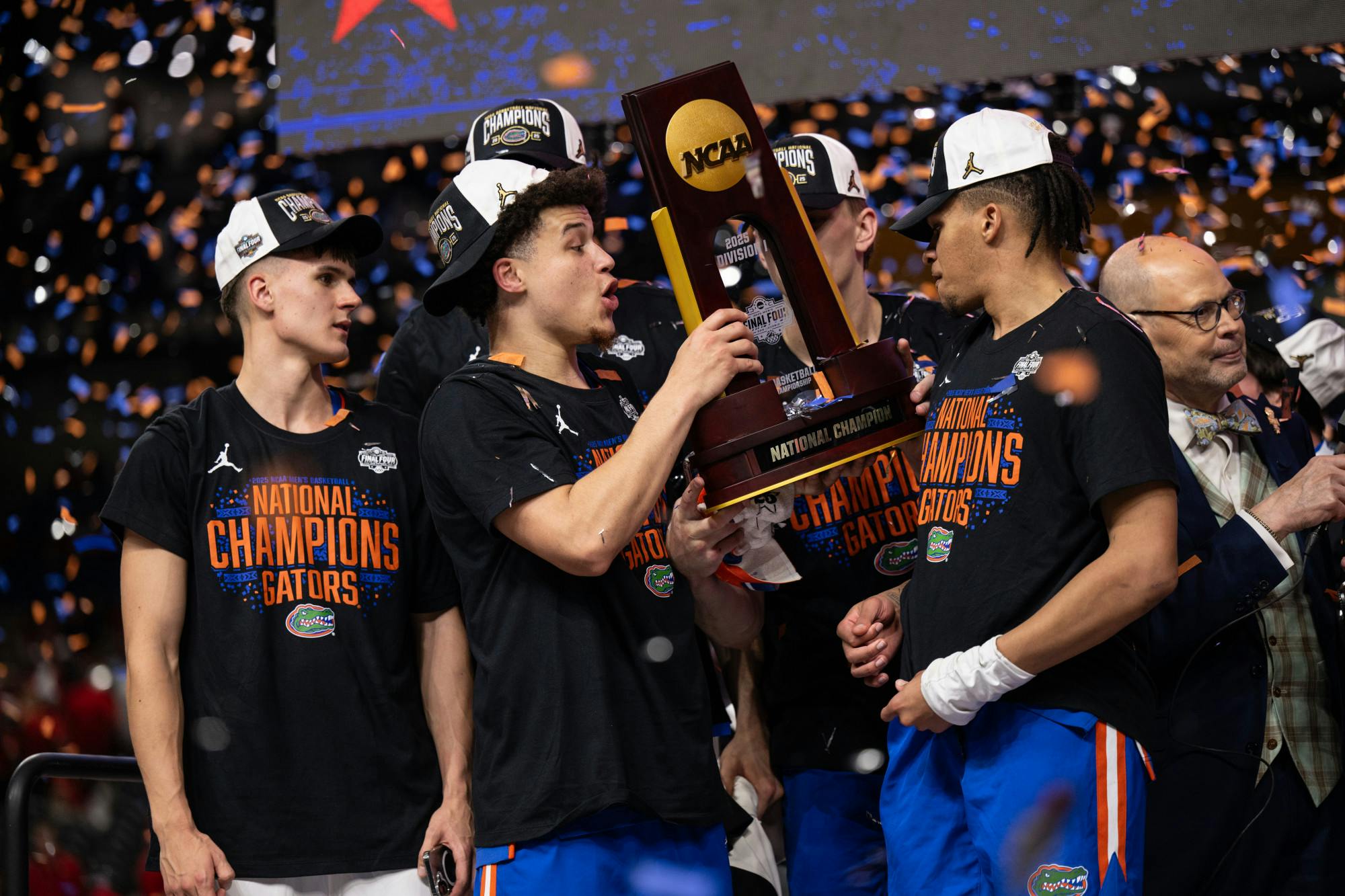 Florida Gators guard Walter Clayton Jr. (1) gets handed the national championship trophy after winning the National Championship against the Houston Cougars in the NCAA Tournament on Monday, April 7, 2025, in San Antonio, Texas.