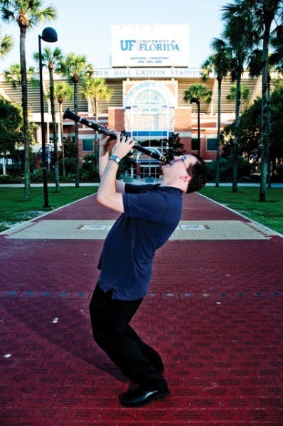 Dale Fedele, who studies political science and music performance, poses with his clarinet outside the Ben Hill Griffin Stadium. The International Clarinet Association hosted an Young Artists Competition, where Fedele placed fourth.