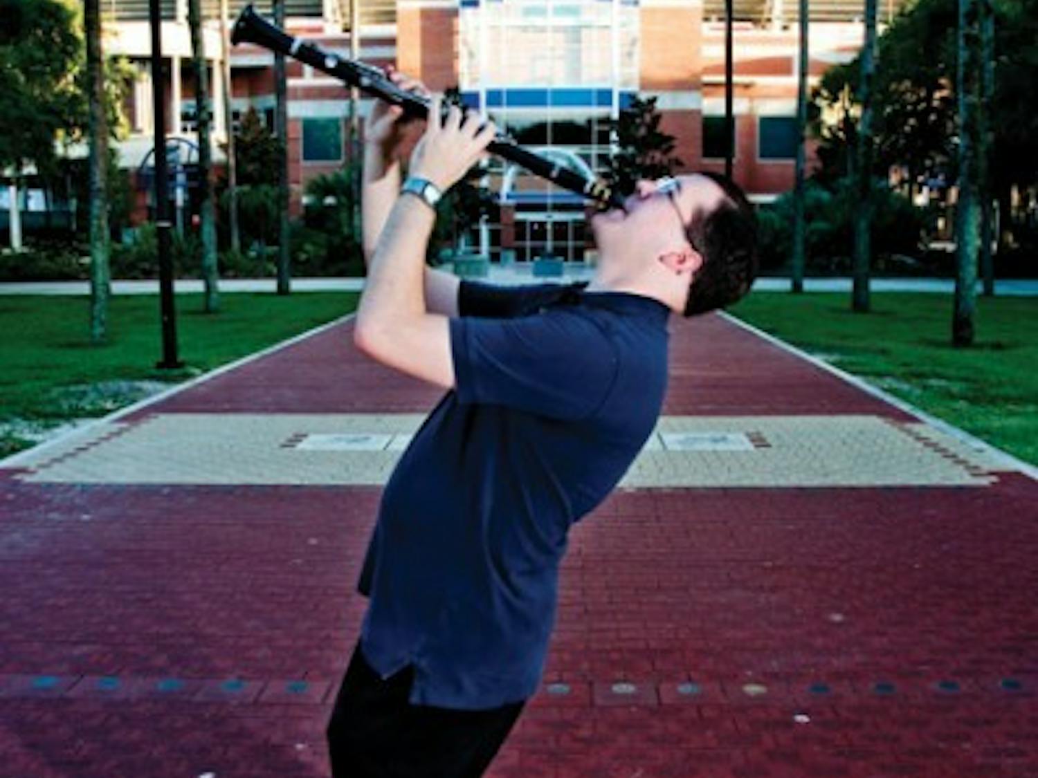 Dale Fedele, who studies political science and music performance, poses with his clarinet outside the Ben Hill Griffin Stadium. The International Clarinet Association hosted an Young Artists Competition, where Fedele placed fourth.