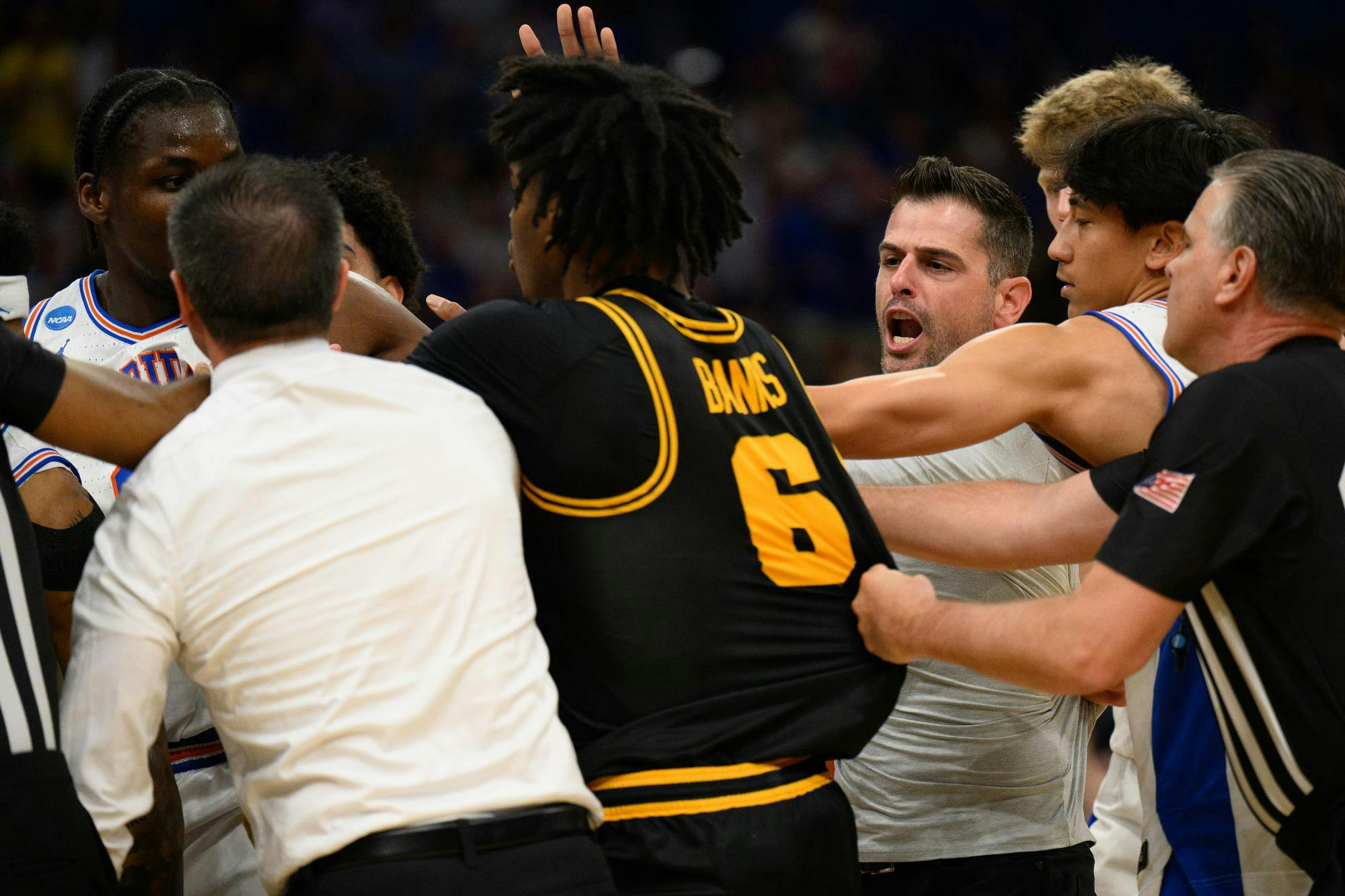 Florida head coach Todd Golden rushes a huddle during the first half of an NCAA Tournament second round game against Iowa, Sunday, March 22, 2026, in Tampa, Fla.