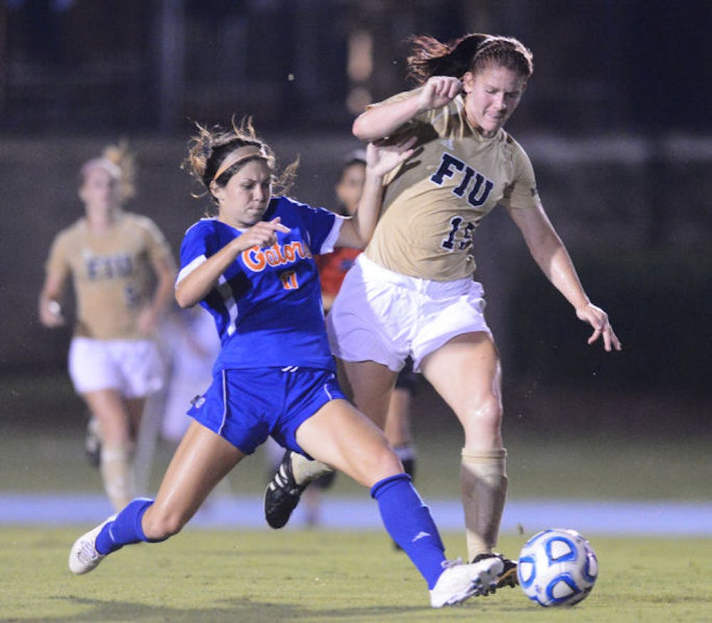 <p>Erika Tymrak goes for the ball against a FIU defender during a match on Sept. 2, 2012. Tymrak led Florida in goals, assists and game-winning goals in her final season as a Gator.</p>