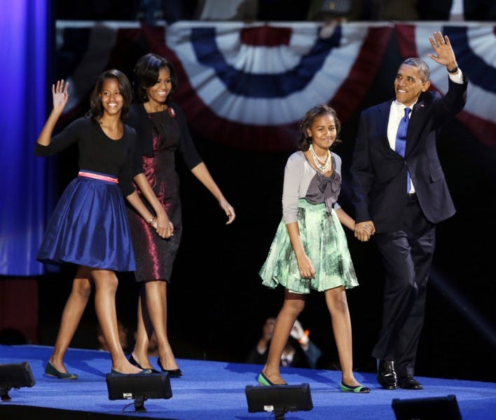 President Barack Obama waves as he walks on stage with first lady Michelle Obama and daughters Malia and Sasha at his election night party Wednesday, Nov. 7, 2012, in Chicago. President Obama defeated Republican challenger former Massachusetts Gov. Mitt Romney. (AP Photo/Chris Carlson)