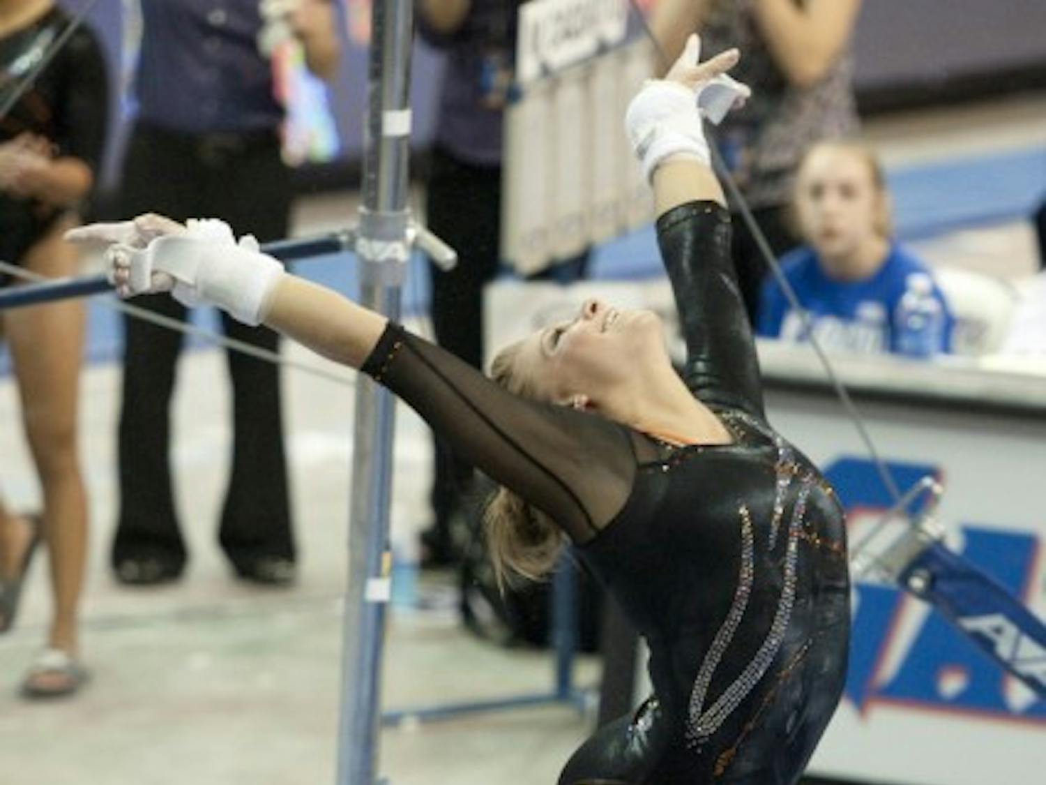 Mackenzie Caquatto sticks a dismount in a quad meet Jan. 27. She rebounded from ankle pain to post 9.9 on bars at the SEC Championship.