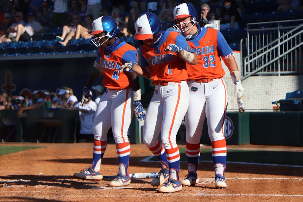 Hannah Adams, Charla Echols and Kendyl Lindaman celebrate at home plate in Florida's 4-0 win over Texas A&M on May 8. The Gators begin their run in the SEC Tournament Thursday.