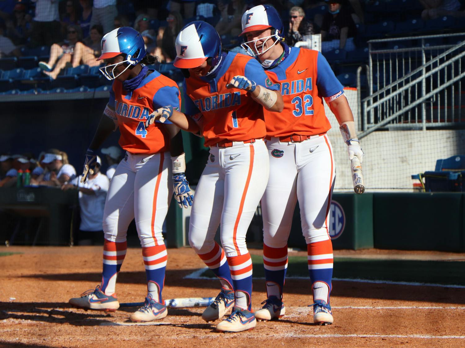 Hannah Adams, Charla Echols and Kendyl Lindaman celebrate at home plate in Florida's 4-0 win over Texas A&M on May 8. The Gators begin their run in the SEC Tournament Thursday.