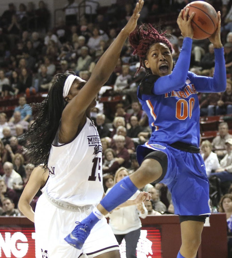Florida guard Delicia Washington (0) drives to the basket around Mississippi State center Teaira McCowan (15) during the second half of an NCAA college basketball game in Starkville, Miss., Thursday, Jan. 12, 2017. (AP Photo/Jim Lytle)