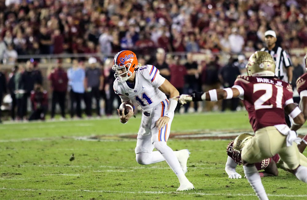 <p>Florida quarterback Jalen Kitna runs the ball against the Florida State Seminoles Friday, Nov. 25, 2022. ﻿Kitna is indefinitely suspended from the Gators football team after being arrested on child pornography charges.</p>