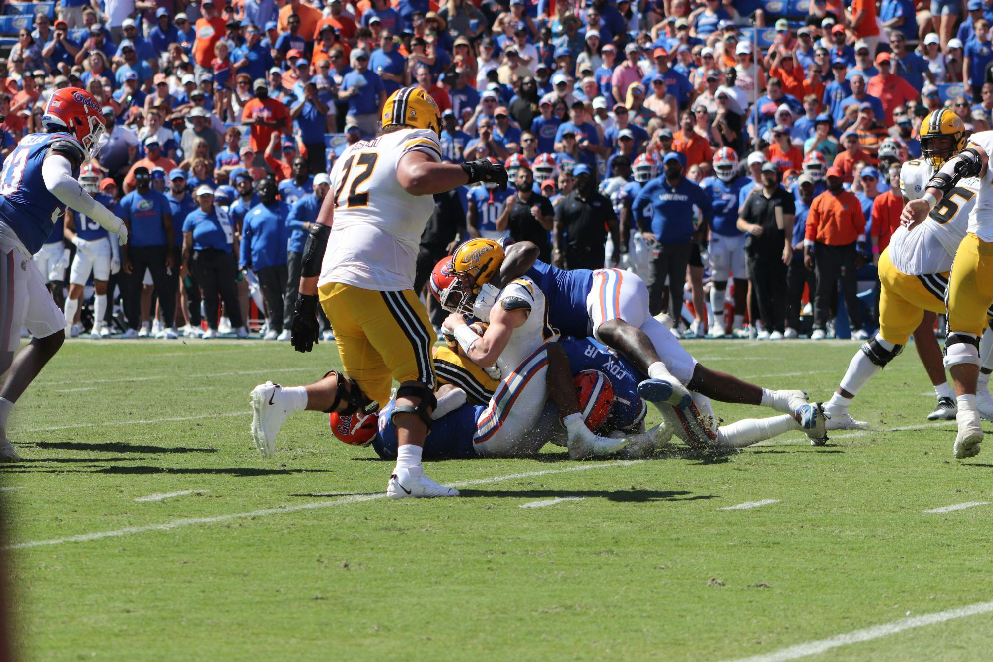 Florida defenders Ventrell Miller, Brenton Cox Jr. and Gervon Dexter Sr. all combine for a sack of Missouri quarterback Brady Cook Saturday, Oct. 8, 2022. 
