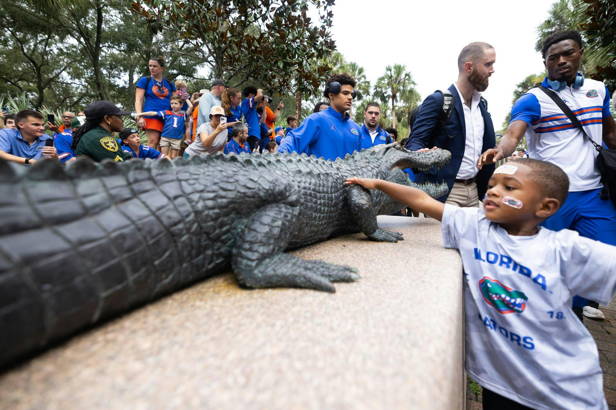Coaches, their families and players of the UF football team, touch the gator statue outside of Ben Hill Griffin Stadium as they walk in for UF’s matchup against University of South Carolina, Saturday, Oct. 10, 2026, in Gainesville, Fla.