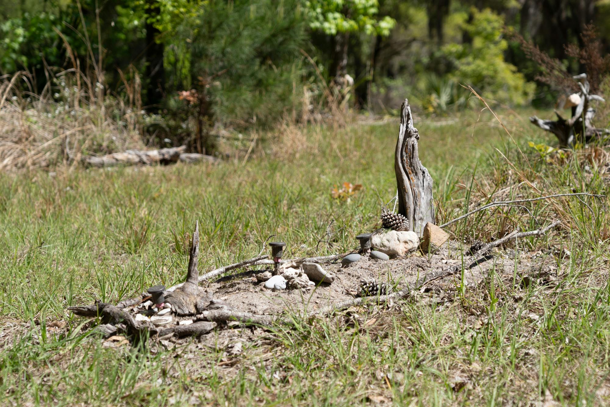 A natural burial site is covered with special objects at Prairie Creek Conservation Sanctuary on Thursday, March 14, 2024.