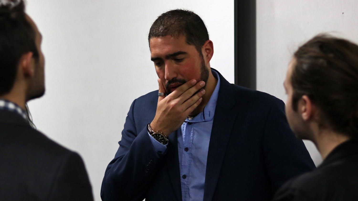 Yoni Michanie, activist and Sgt. 1st Class in the Israeli Defense Force, talks with students Tuesday night after speaking in Little Hall.