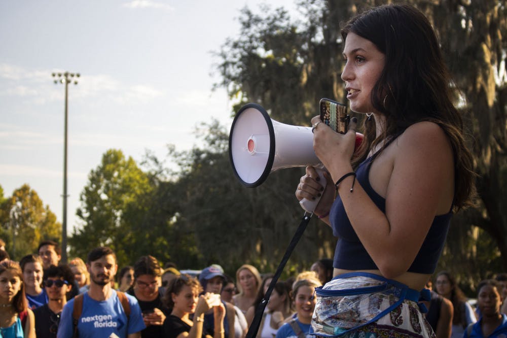 Samantha Gildea, a 20-year-old international studies and Russian studies double major sophomore, speaks to a crowd of about 200 protesters Tuesday afternoon during the protest for blue lights on Frat Row. The protest took place in Flavet field. Gildea is an organizer for the protest and a member of Pi Beta Phi Fraternity for Women, the only female fraternity located on fraternity drive.