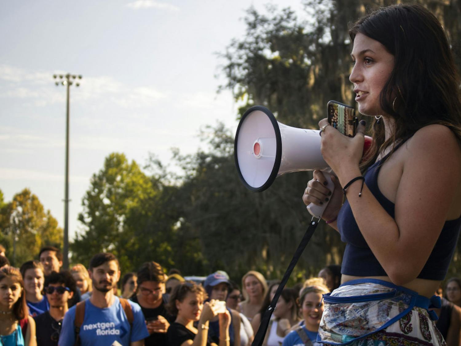 Samantha Gildea, a 20-year-old international studies and Russian studies double major sophomore, speaks to a crowd of about 200 protesters Tuesday afternoon during the protest for blue lights on Frat Row. The protest took place in Flavet field. Gildea is an organizer for the protest and a member of Pi Beta Phi Fraternity for Women, the only female fraternity located on fraternity drive.