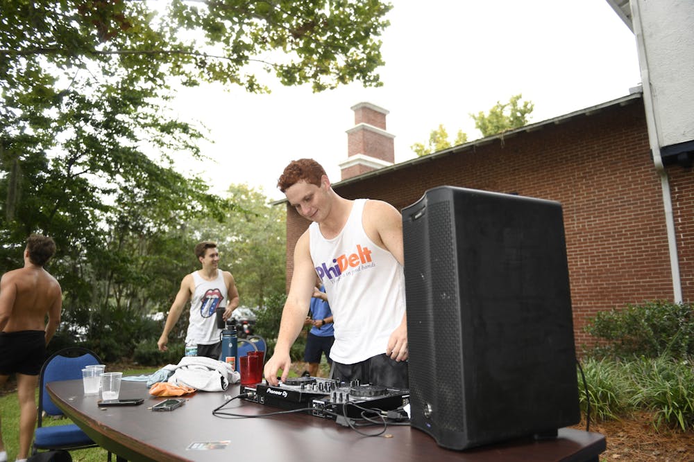 <p>Phi Delta Theta Brother Eli Bloom DJs outside of the Phi Delta Theta house on a “Front Lawn Friday” on September 6, 2024.</p>