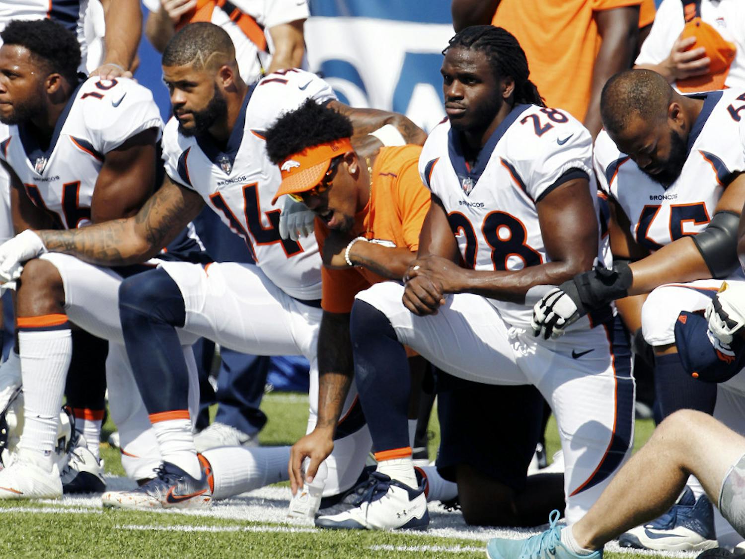 Denver Broncos players, including Jamaal Charles (28) kneel during the national anthem prior to an NFL football game against the Buffalo Bills, Sunday, Sept. 24, 2017, in Orchard Park, N.Y. (AP Photo/Jeffrey T. Barnes)