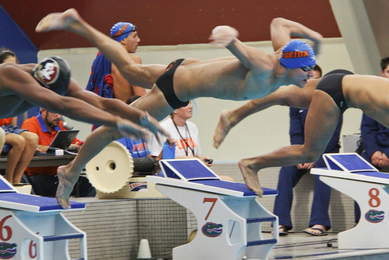 Freshman Caeleb Dressel jumps into the pool at the start of the 200-yard breaststroke event during Day 3 of the 2014 Pinch A Penny Invitational