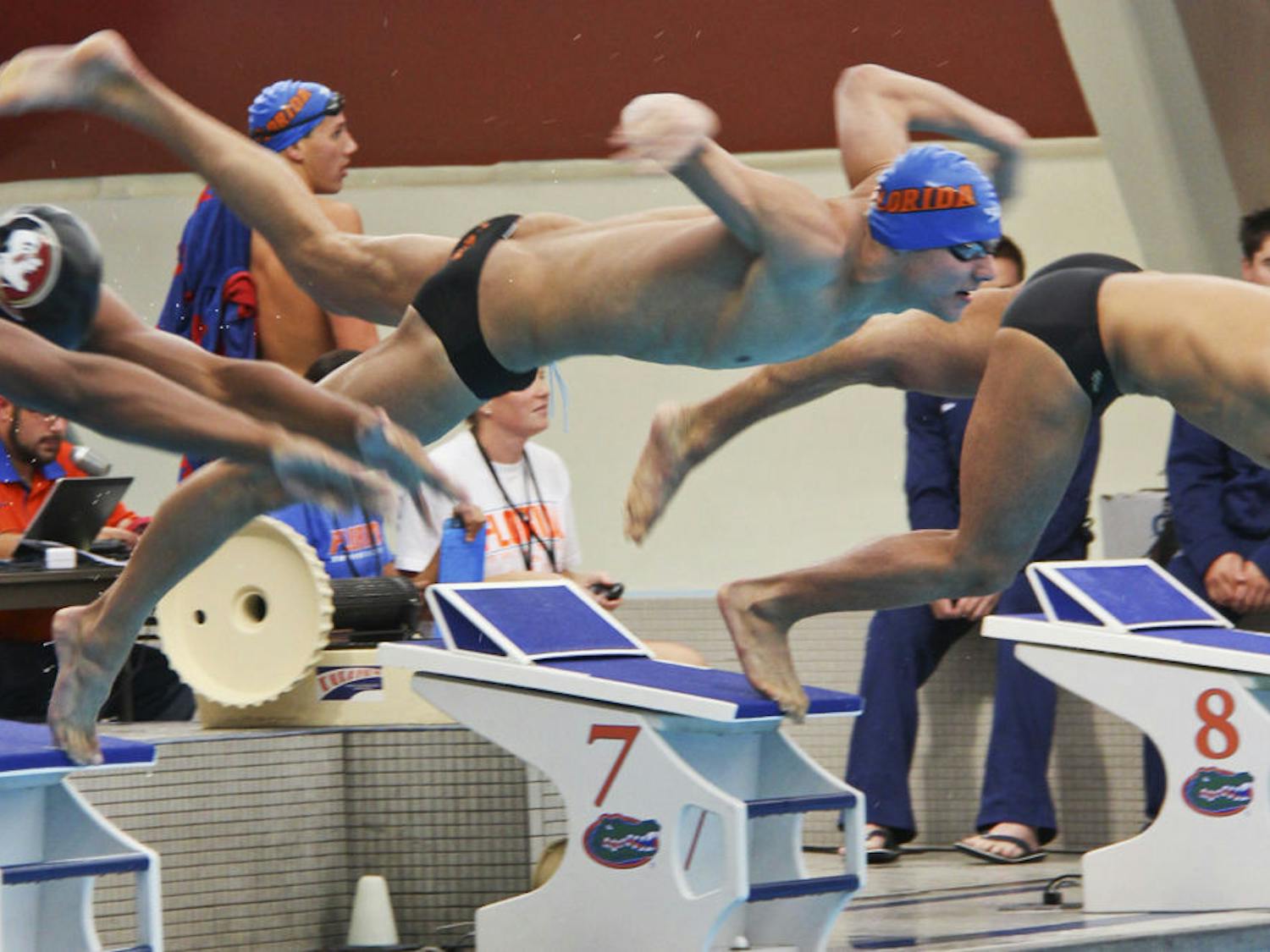 Freshman Caeleb Dressel jumps into the pool at the start of the 200-yard breaststroke event during Day 3 of the 2014 Pinch A Penny Invitational