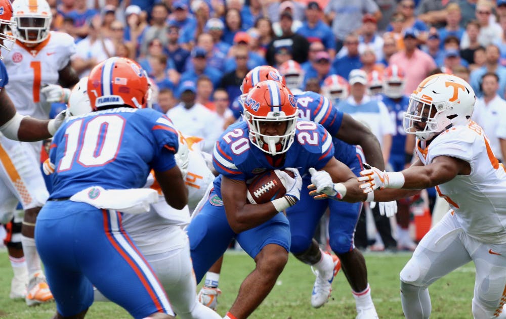 <p>UF running back Malik Davis (20) runs with the ball during Florida's 26-20 win against Tennessee on Saturday at Ben Hill Griffin Stadium.</p>