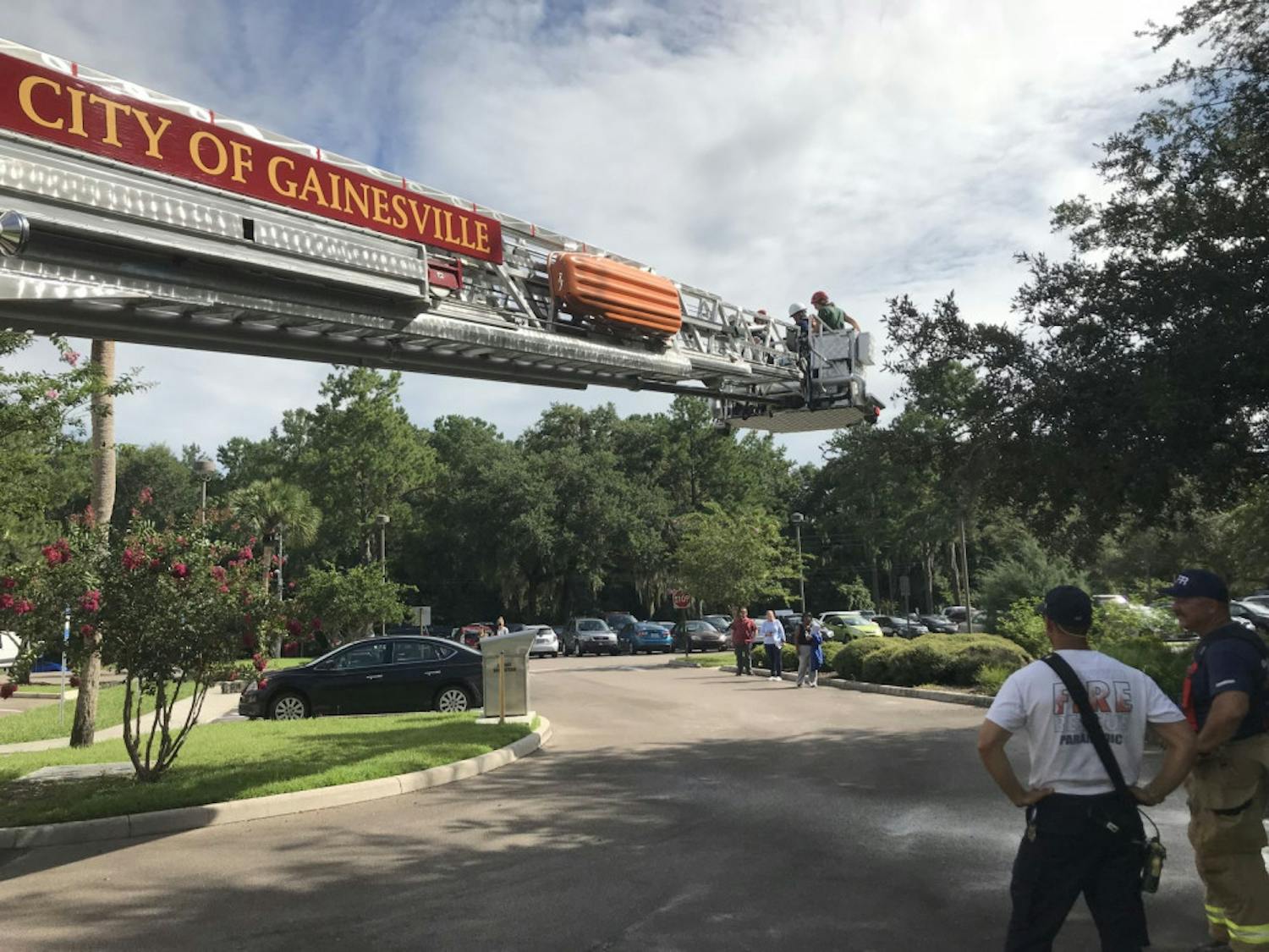 Gainesville firefighters watch as the fire truck’s basket is lifted into the air.
&nbsp;