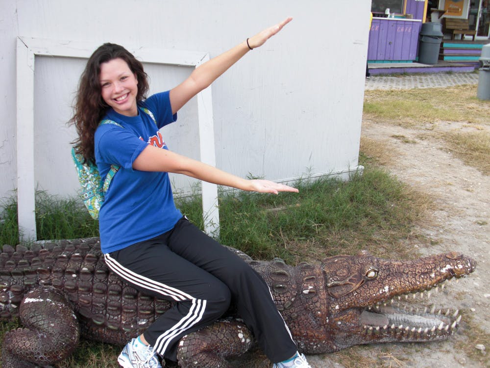<p>Callie Pitman, 26-year-old UF alumna, does a Gator chomp while she waits for her first skydiving trip when she was 20.</p>