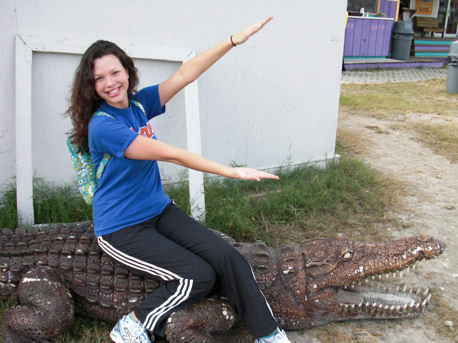 Callie Pitman, 26-year-old UF alumna, does a Gator chomp while she waits for her first skydiving trip when she was 20.