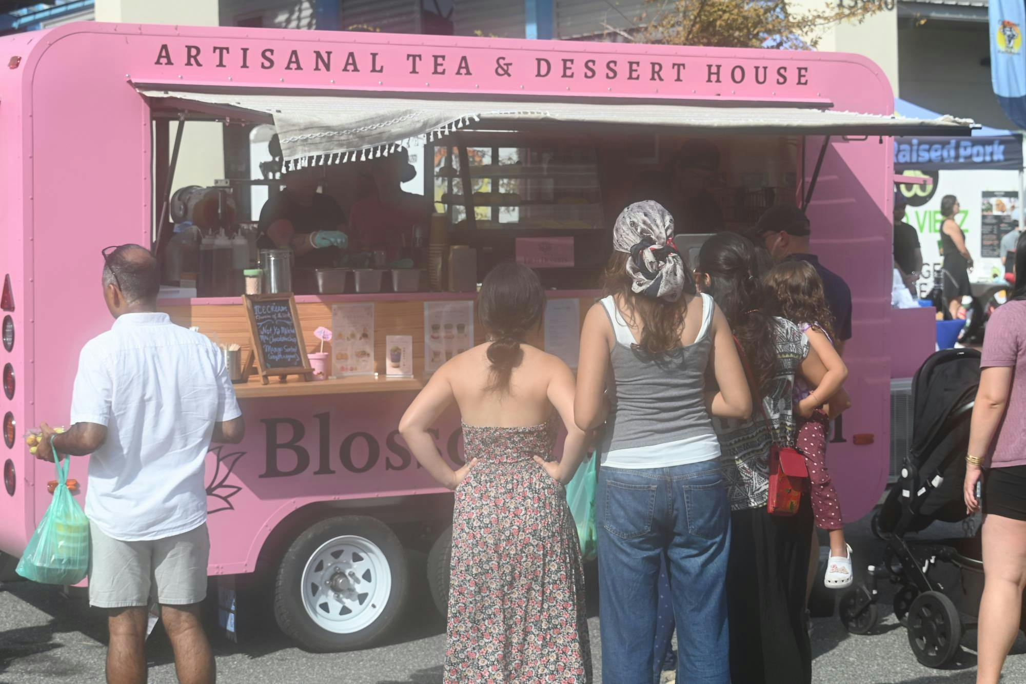 Blossom and Bloom treats customers at the Alachua County Farmer's Market on July 25, 2026. 