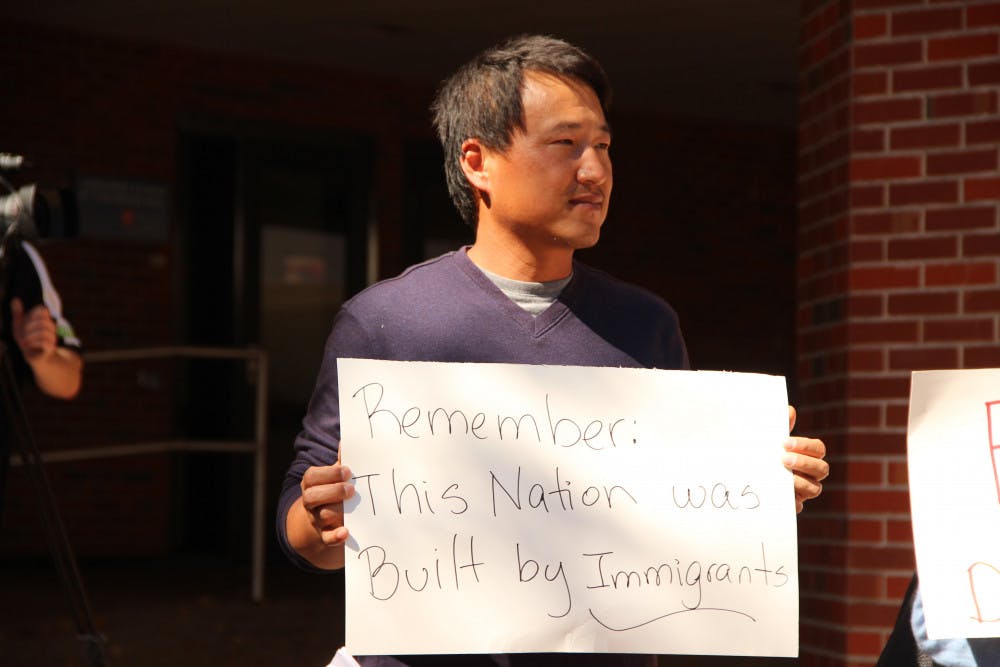 Sangdon So, a visiting scholar for UF's College of Engineering who is originally from South Korea, protests in support of immigrants. He said he would like to get a green card and live with his family in the U.S., but he is uncertain that this will be a possibility for him.