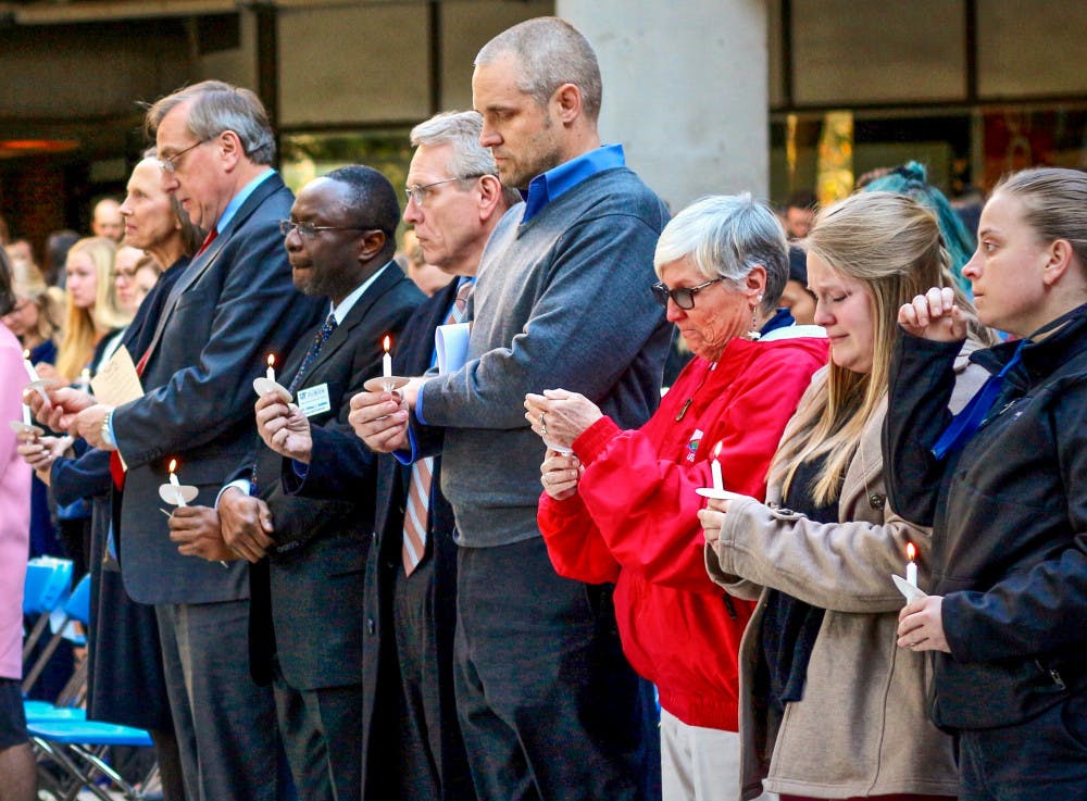 About 350 students and faculty from UF gather at the School of Architecture while Joshua Pearsaul sings “Amazing Grace” at the vigil held for Caroline Alfano. 