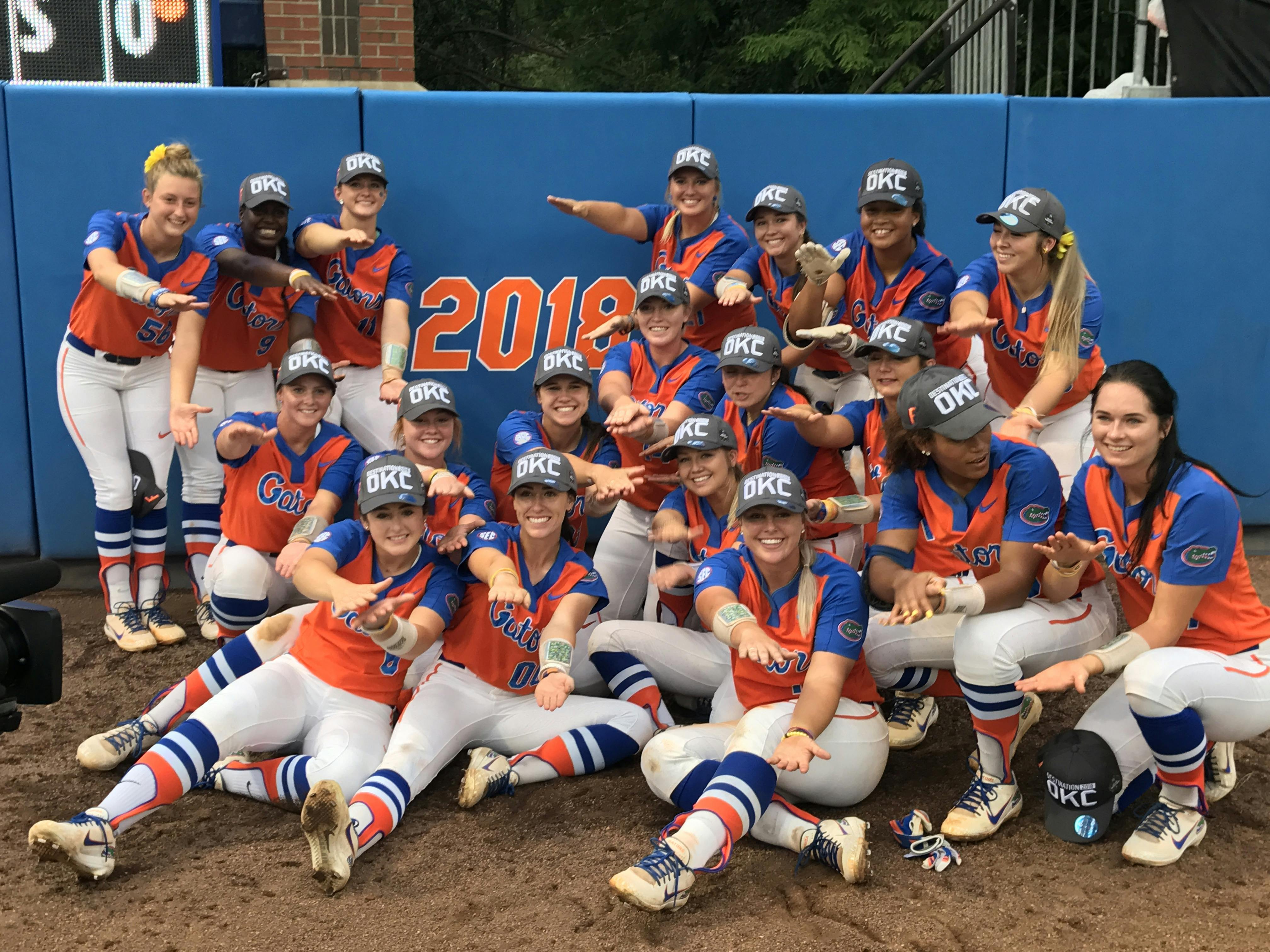 The Florida Gators softball team in front of its newly earned 2018 College World Series sign. UF won on a walk-off home run by freshman Jordan Matthews to send it to Oklahoma City. 