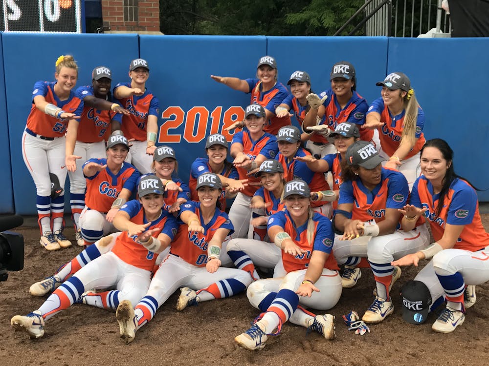 <p>The Florida Gators softball team in front of its newly earned 2018 College World Series sign. UF won on a walk-off home run by freshman Jordan Matthews to send it to Oklahoma City. </p>