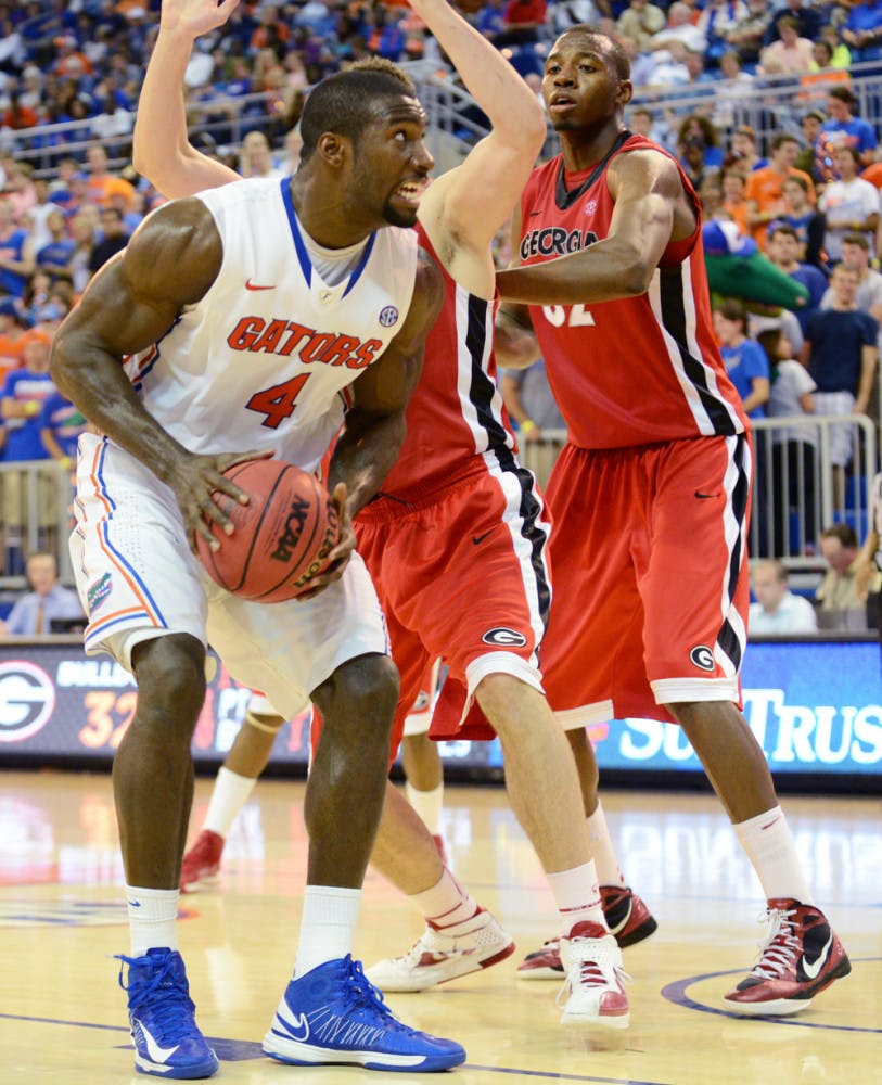 Center Patric Young (4) pulls down a rebound during UF's 77-44 win against Georgia on Wednesday night in the the O'Connell Center 