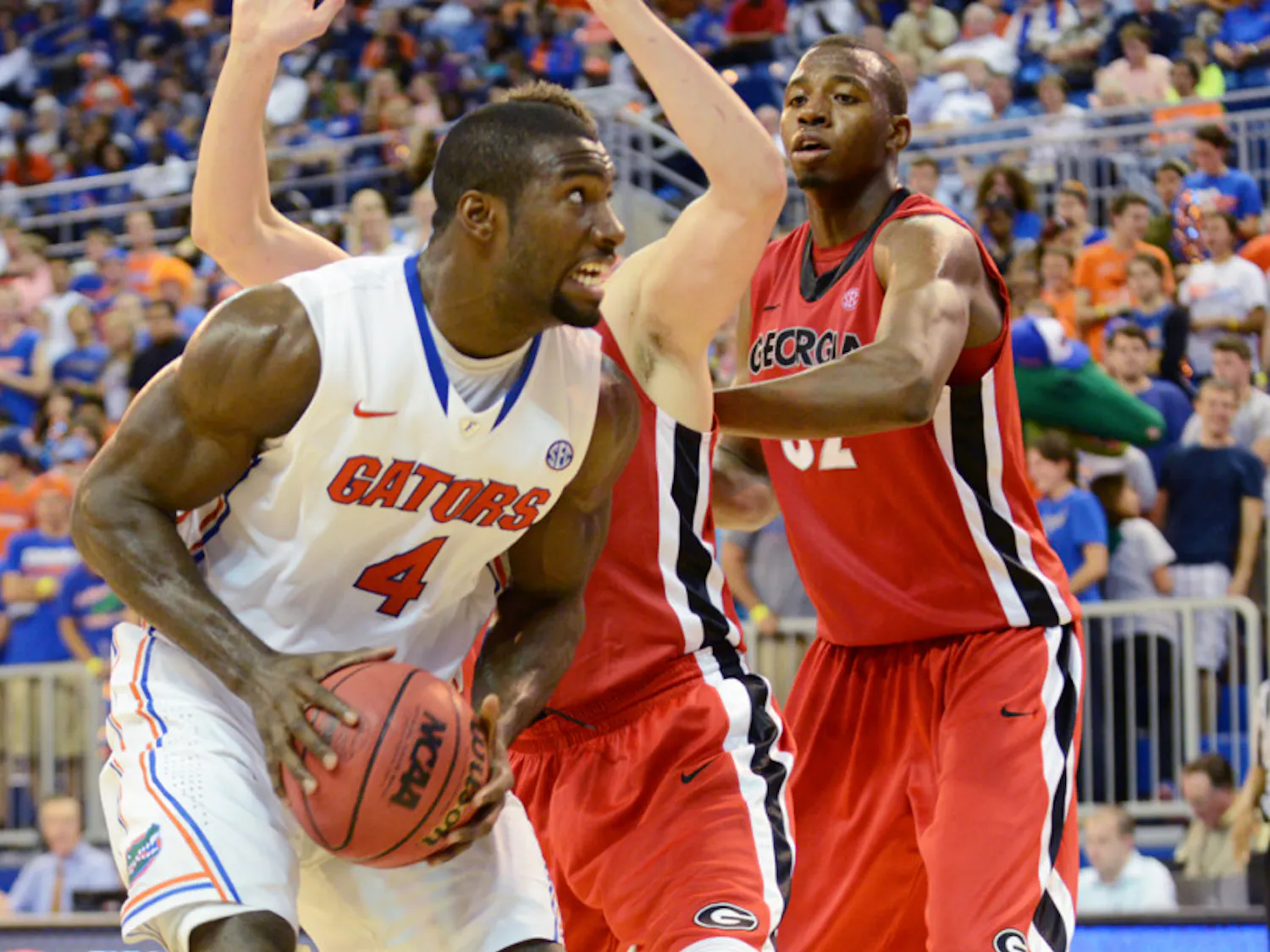 Center Patric Young (4) pulls down a rebound during UF's 77-44 win against Georgia on Wednesday night in the the O'Connell Center