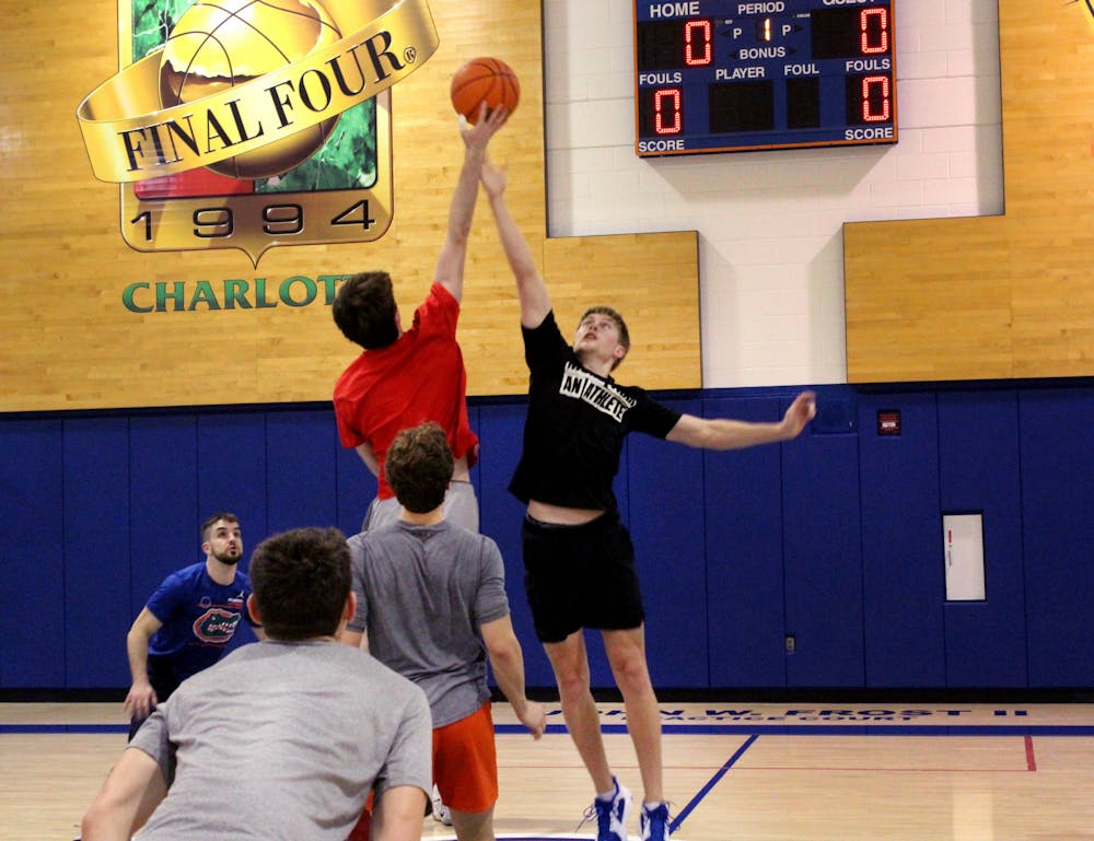 UF basketball manager Bennett Andersen leaps for the jump ball against UGA's managers on Thursday, Feb. 10 at the Florida Basketball Practice Complex. 