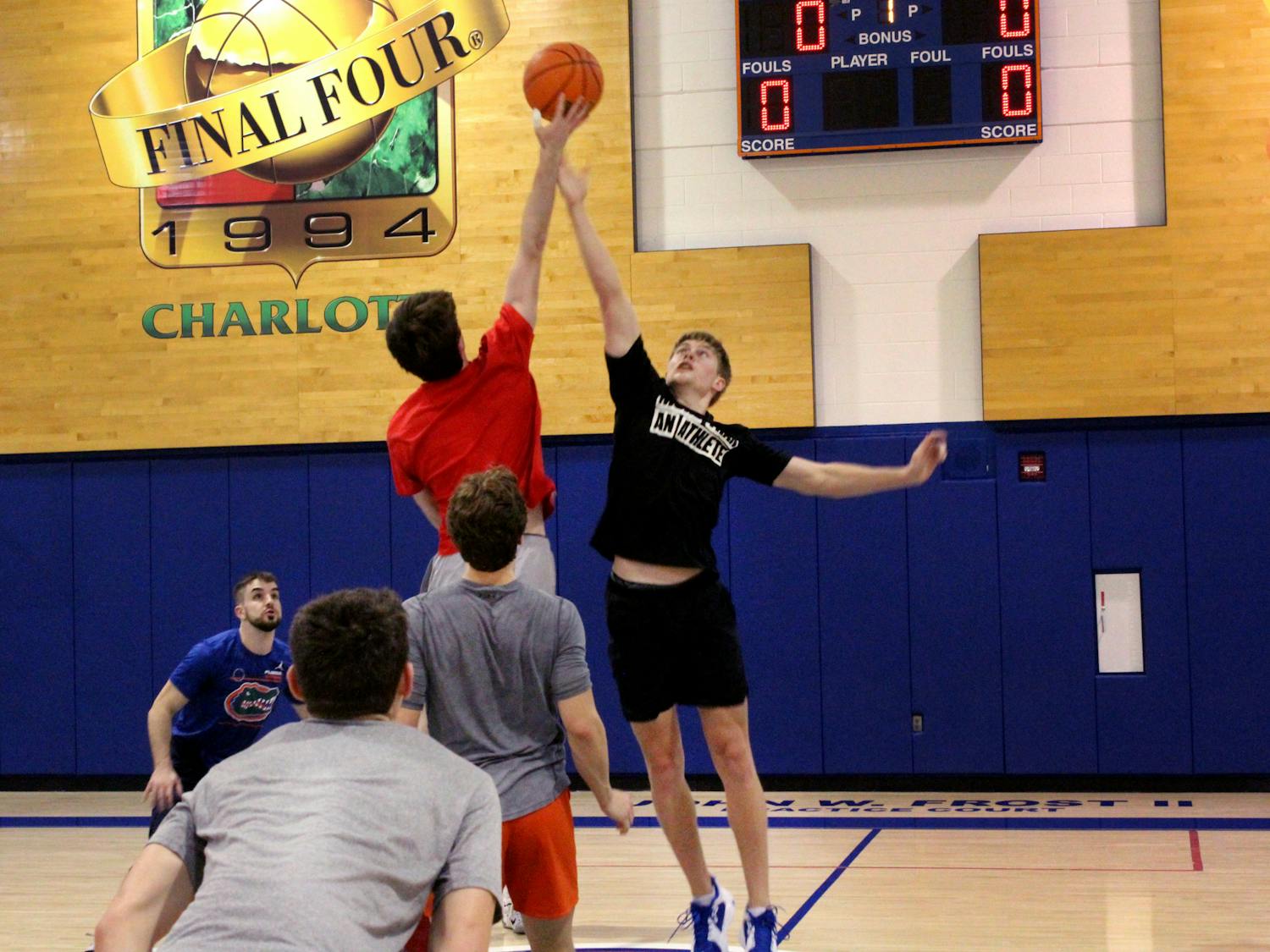 UF basketball manager Bennett Andersen leaps for the jump ball against UGA's managers on Thursday, Feb. 10 at the Florida Basketball Practice Complex.