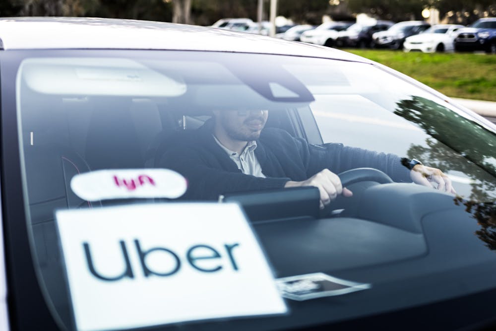 <p>Local rideshare driver Andres Esteller sits in his car on Museum Road in Gainesville, Florida, on Thursday, January 16, 2025.</p>