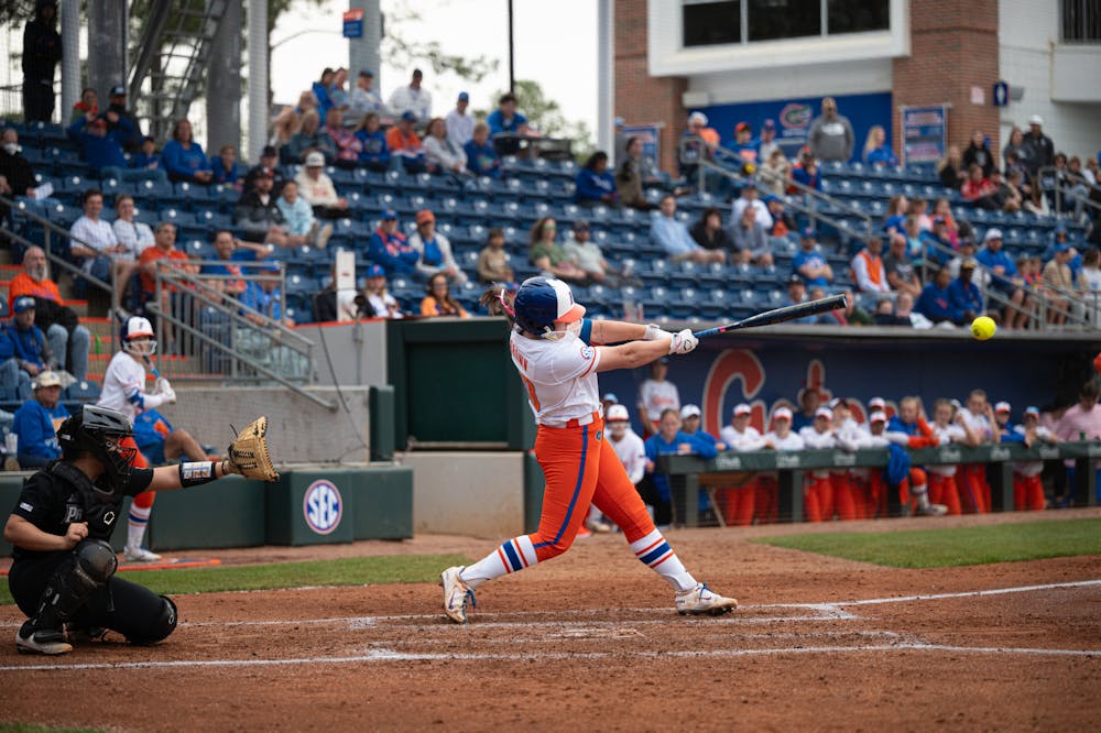 Florida Gators pitcher/first baseman Ava Brown (00) swings in a softball game against Providence in Gainesville, Fla., on Friday, Feb. 14, 2025.