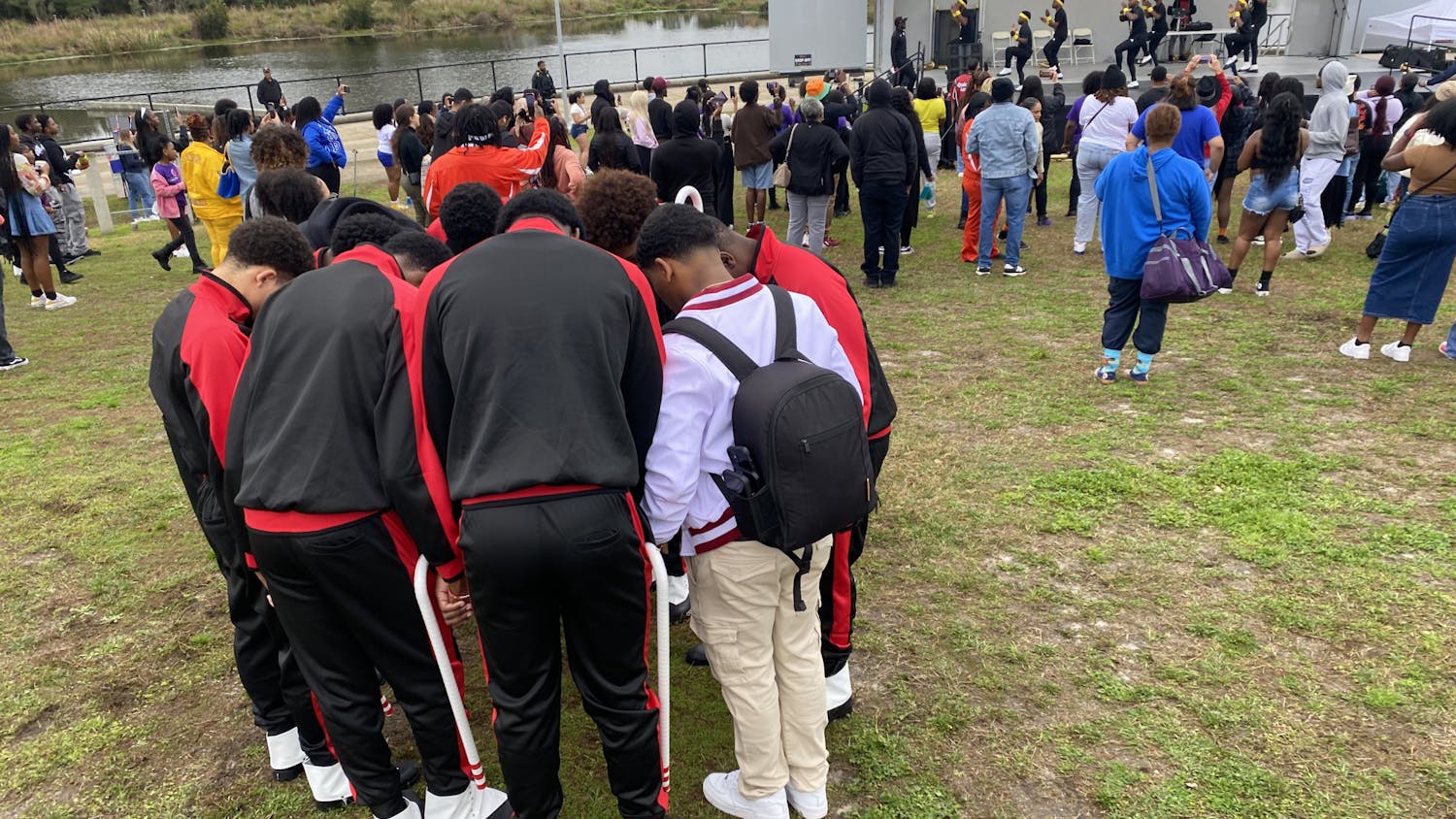 Members of Kappa Alpha Psi Fraternity exchange words of encouragement before their performance for the UFFISS Stroll Off competition at Depot Park on Feb. 17, 2024.