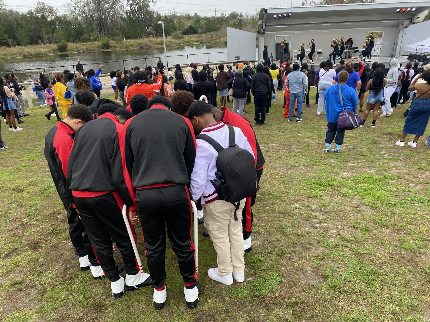 Members of Kappa Alpha Psi Fraternity exchange words of encouragement before their performance for the UFFISS Stroll Off competition at Depot Park on Feb. 17, 2024.